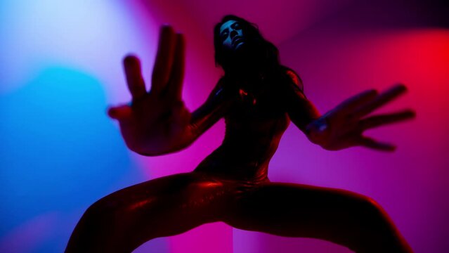 Female dancer posing against colourful background