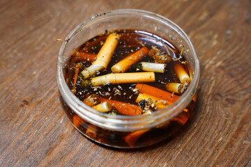 Cigarettes are left in dirty tare water after use.