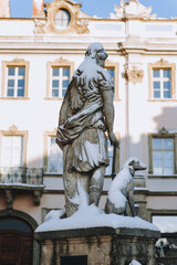 Fototapeta na wymiar Statue of the goddess of hunting Diana with a dog, view from the back. Historical center of Lviv near the town hall on the square in Lviv, Ukraine.
