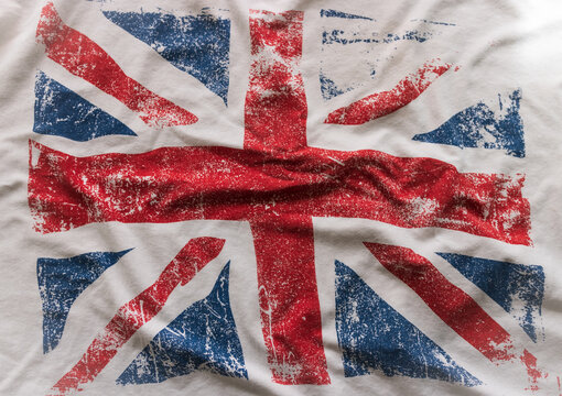 Textured background of the British flag in white, red and blue national colors. blur, defocus.
