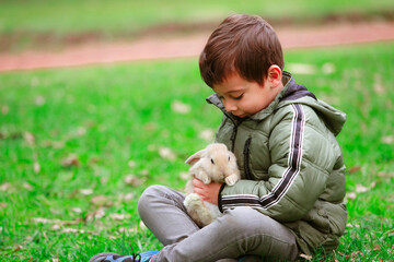Hispanic boy with a rabbit in the park