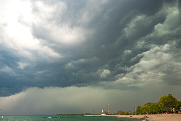 A storm cell moves over a beach on Lake Ontario.  Shot in Toronto's Beaches neighbourhood in May. Space for text.