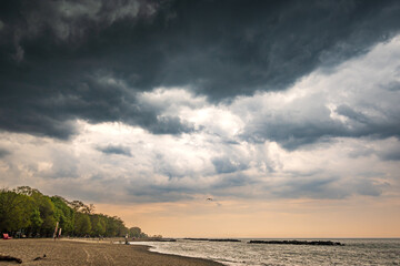 A storm cell moves over a beach on Lake Ontario.  Shot in Toronto's Beaches neighbourhood in May. Space for text.