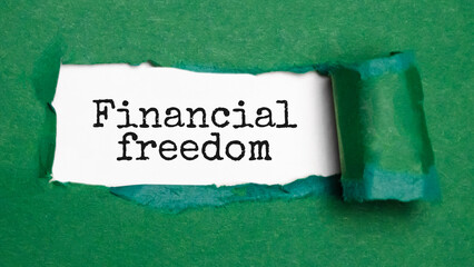 Text Financial Freedom appearing behind ripped brown paper