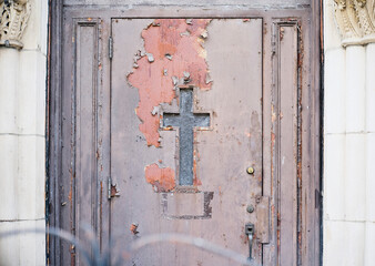 old wooden door with crucifix of a church