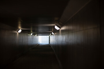 Tunnel with lamps. Long tunnel in building.