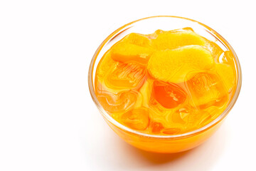 Marian plum fruits in syrup with ice in glass bowl on white