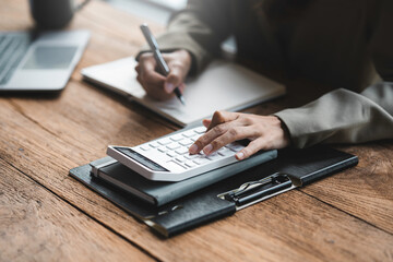 Businessman or accountant working on calculator to calculate business data concept....