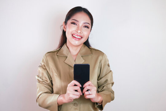 Smiling government worker women holding and pointing screen on smartphone. PNS wearing khaki uniform.
