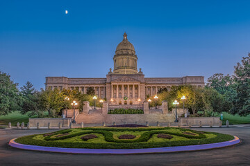 Illuminated Kentucky State Capitol at dusk with warm lights illuminating this great capitol with a blue sky  on a warm summer evening in Frankfort, KY.