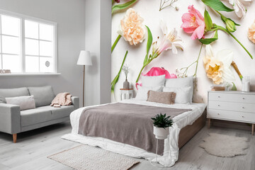 Stylish interior of modern bedroom with printed beautiful flowers on wall