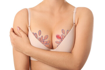 Young woman in bra on white background. Breast cancer awareness concept