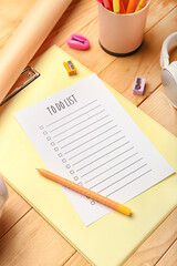 Blank to do list, clipboard and pen on wooden background