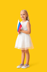 Cute little girl with national flag of Russia on color background