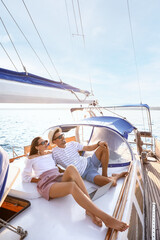 Happy young couple resting on yacht