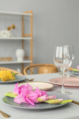 Plate with beautiful Gladiolus flower on dining table