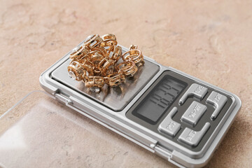 Jewelry scales with chain on beige background
