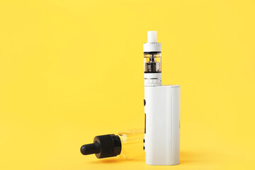 Modern vape mod and oil on yellow background