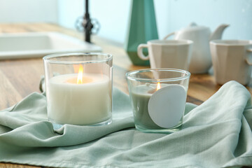 Holders with burning candles on table, closeup
