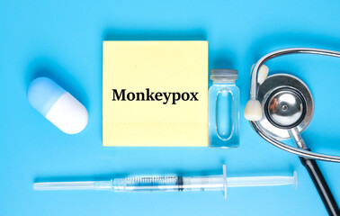 A picture of notepad written monkeypox, stethoscope ,medicine and vaccine. Monkeypox is virus...