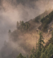 Vivid sunrise in the mountains with fog in the valley. Fog rolled through the valleys below the hills. 