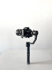 modern camera equipment, black stabilizer tripod with video cinema camera