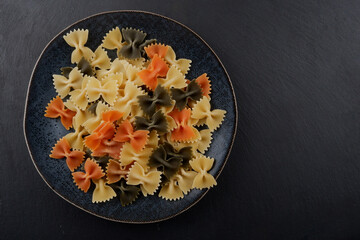 butterfly pasta is lying on a plate.farffalle