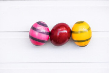 Colored eggs on a trendy background. Geometry. The minimal concept. Top view. An Easter card with a copy of the place for the text.