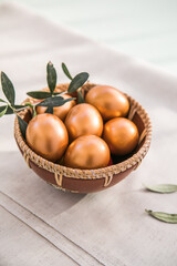 Golden  eggs in bowl. The minimal concept. An Easter card with a copy of the place for the text.