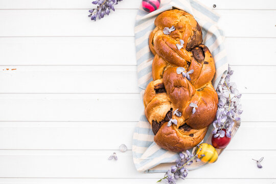 Tsoureki traditional baked Greek Easter sweet bread.  Easter time, springtime. Holiday food concept. Top view, flat lay, copy space