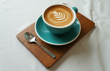 Close up hot cappuccino white coffee cup with heart shape latte art on dark brown old wood table at caff food and drink concept.