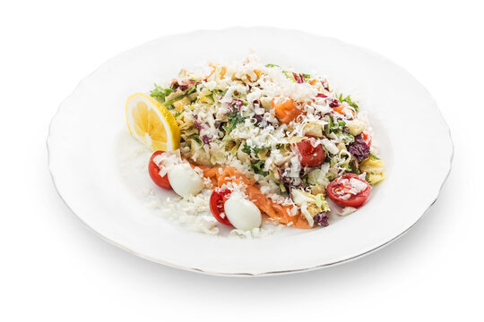 Salad with red fish in a plate. Photo of food on a white background