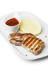 Pork chop, meat in a plate. Photo of food on a white background