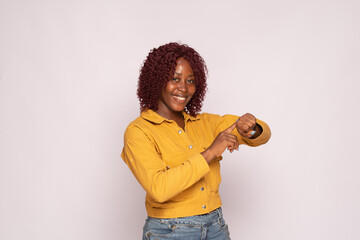black lady pointing to her watch, time conscious gesture