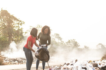 black women cleaning up a dump site