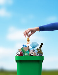 Woman putting trash in a waste bin