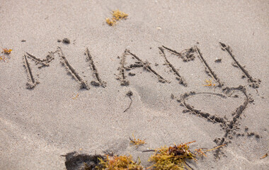 The word Miami is written in the sand. Recreation concept. Selective focus