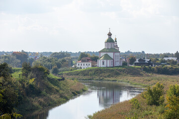 The Church of Elijah the Prophet was built in 1744 and is located in the bend of the Kamenka River, opposite the Suzdal Kremlin. Religion concept. Suzdal, Vladimir region, Russia - SEPTEMBER 12, 2021