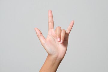 Woman's hand giving the Rock and Roll sign, devil horns gesture