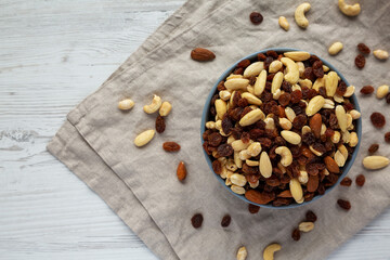Raw Trail Mix with Nuts and Fruits in a Bowl, top view. Flat lay, overhead, from above. Copy space.