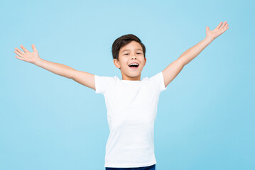 Cute happy smiling handsome mixed race boy with open arms in isolated light blue color studio background - obrazy, fototapety, plakaty