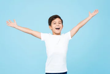 Foto op Canvas Cute happy smiling handsome mixed race boy with open arms in isolated light blue color studio background © Atstock Productions