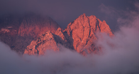 Mountain peak at sunrise on a foggy morning