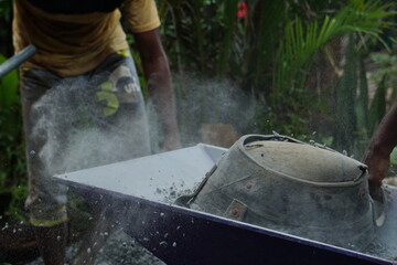 Workers filling baby chilly metals in a carrier