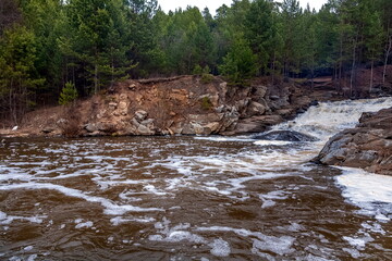 Waterfall on the river with rocky shores . Russia. Ural.