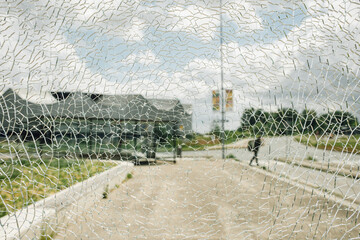 cracked glass window with street scene in background