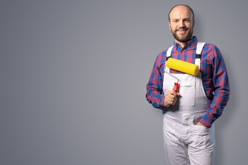 Professional painter posing with paint roller © StockPhotoPro