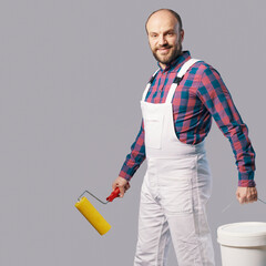 Professional painter posing with paint roller © StockPhotoPro