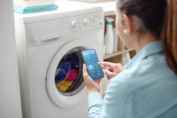 Woman using a smart washing machine