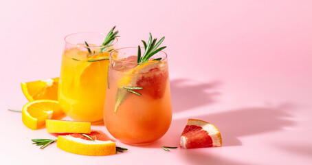 Summer cocktails with grapefruit, orange, rosemary, and ice.